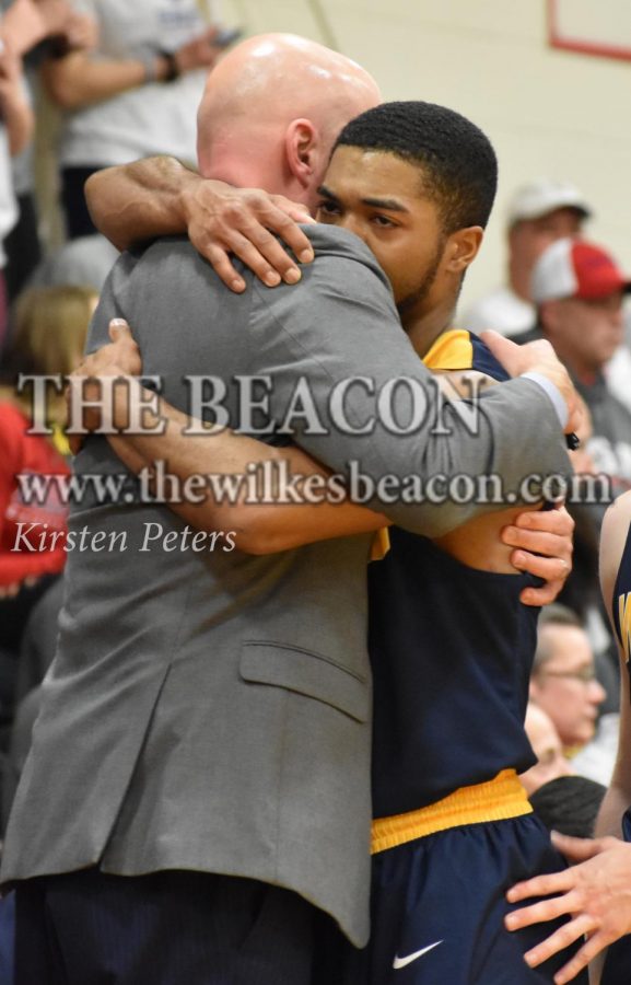 Wilkes head coach Izzi Metz embraces distraught senior guard Marcus Robinson after losing in his last chance at a conference title.