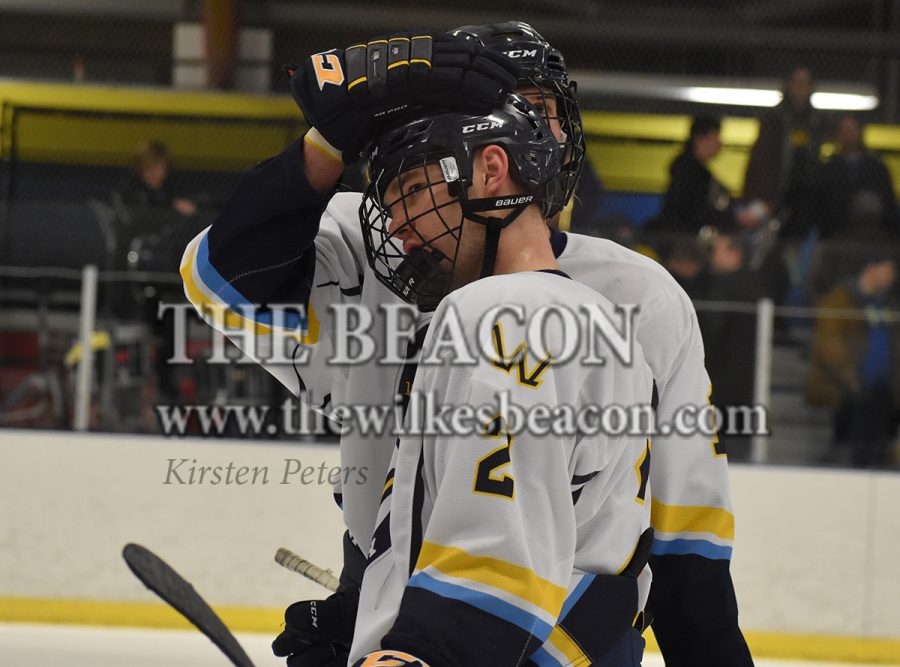 Freshman defenseman Michael Gurska consols fellow defenseman Chris Dalfara following Wilkes’ loss before returning to the locker room for the last time this season.