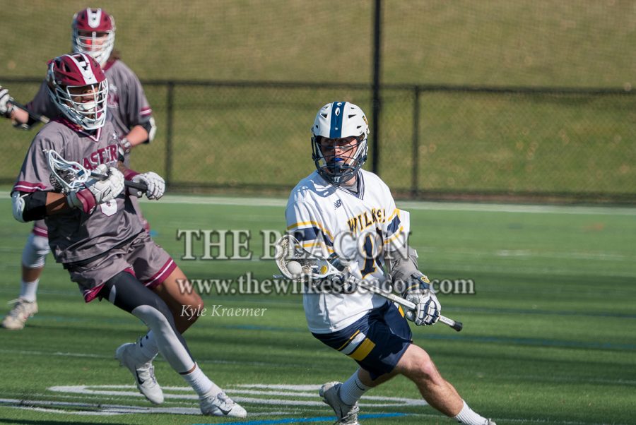 Senior Jacob Kadis tried to veer away from an Eastern defender in the Colonels 10-9 overtime loss against the Eagles on Wednesday afternoon.