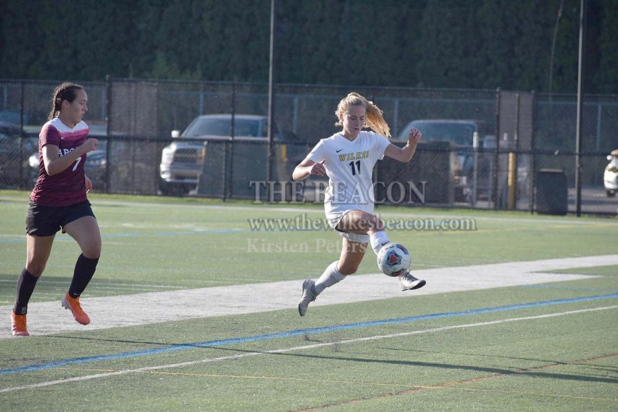 Senior Emily Egan jumps for the ball in the Colonels Sept. 21 contest against Arcadia. This past Saturday E. Egan passed to sister Jessica Egan for the second goal of Wilkes overtime thriller against Eastern. 