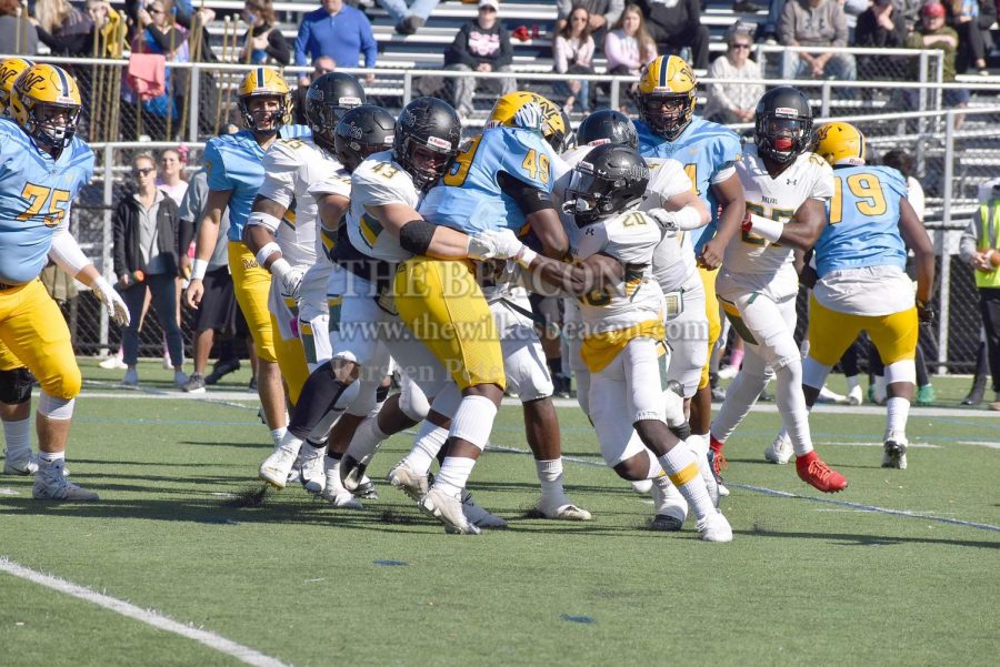 Sophomore fullback Jeremiah Acker was held by a swarm of Aggie defenders in a moment that depicts the tone of the game with Wilkes being trumped by Del Val.