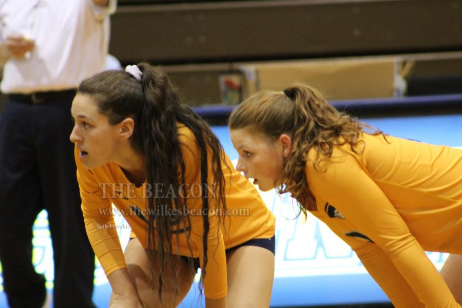 Senior Michele Natale (left) and sophomore Karlye Huffman (right) watch in anticipation during their 3-0 sweep against FDU.
