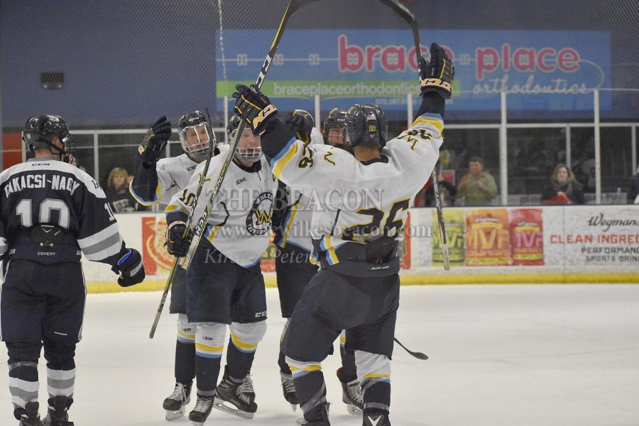 The Colonels celebrate after sophomore forward Joey Pasquini (No. 26) scores his first collegiate goal to tie the game at 3-3 in the third period.