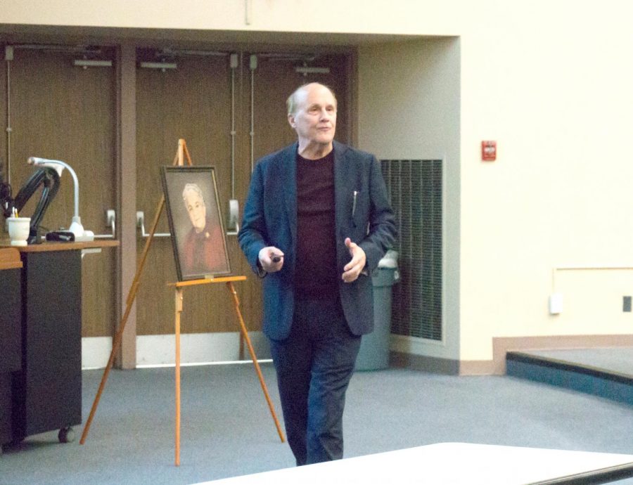 Pownall speaks about his research efforts, Catherine Bone is pictured behind him.