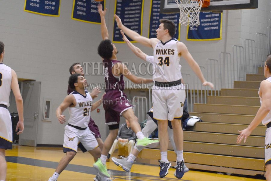 Derek Heiserman goes for a block on Eastern guard Draig Ruff. Heiserman finished the game with eight points and eight rebounds.