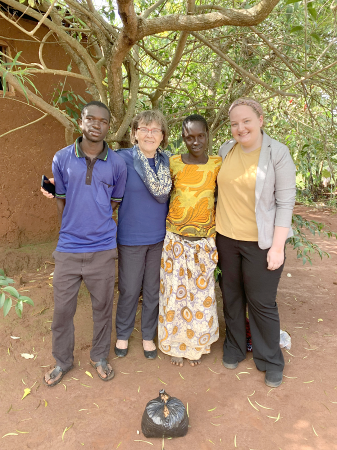 Winkler+and+Plumhoff+pose+alongside+their+friend+Alimwenda+and+her+son+Mjuni+in+Tanzania.