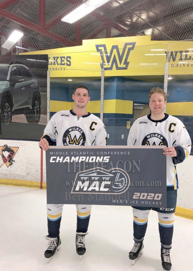 Captains Michael Gurska and Tyson Araujo pose with the MAC banner.