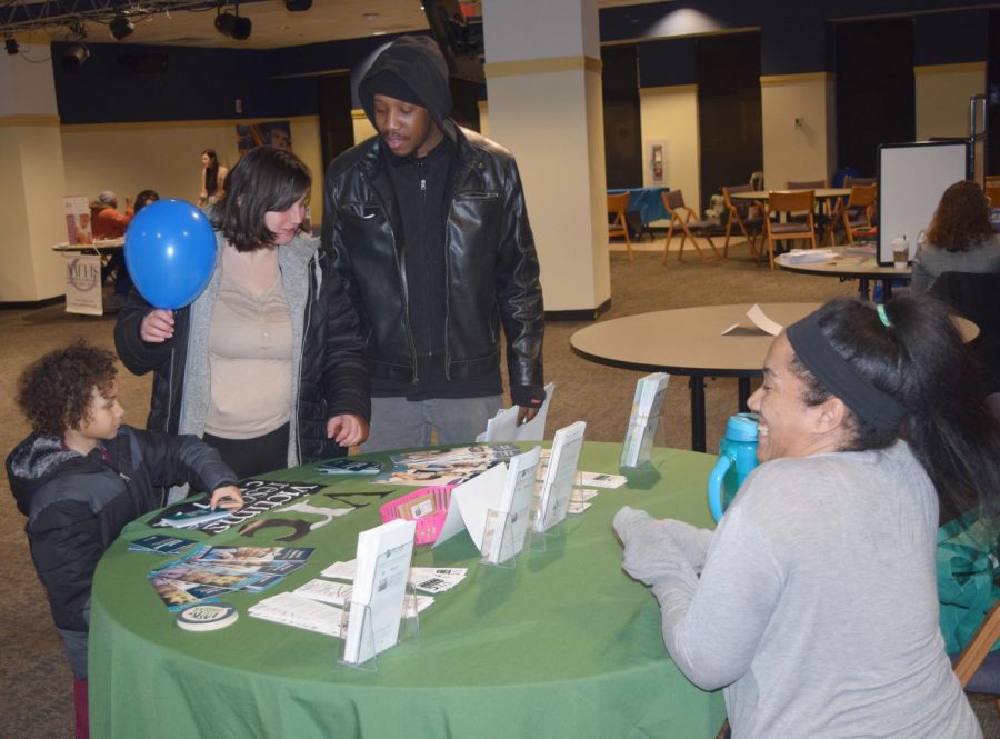 Stephan Moore, Jennifer Haasz and 5-year old Josiah Haasz speak with Eryka Vargas, prevention education specialist at the Victims Resource Center about the confidential nature of the VRC and the services available  to families.