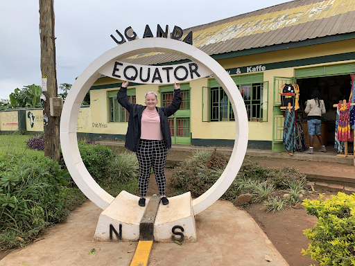 Plumhoff poses at a sign marking the Equator, which runs through the far south of Uganda.