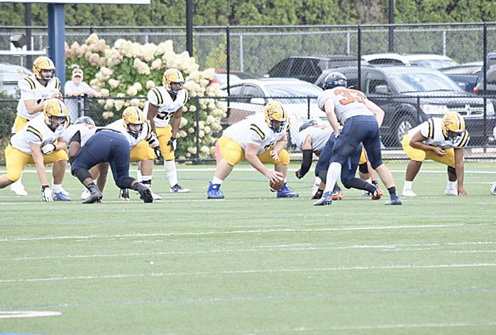 Martel (center) got into position to snap the ball to his quarterback.