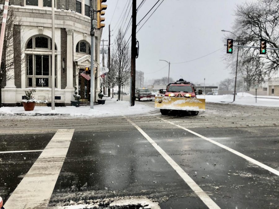 Multiple plow trucks turned onto South Main Street. 