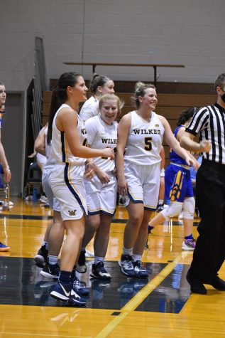 The Colonels celebrate after guard Kendra Smith (center) scored in the paint.