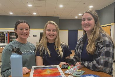 From left to right: Julie Chropowicki, graduate assistant of student development/MBA, Kimberly Wheeler, sophomore pharmacy major, and Kylie Jayne, junior nursing major, doing some diamond art.