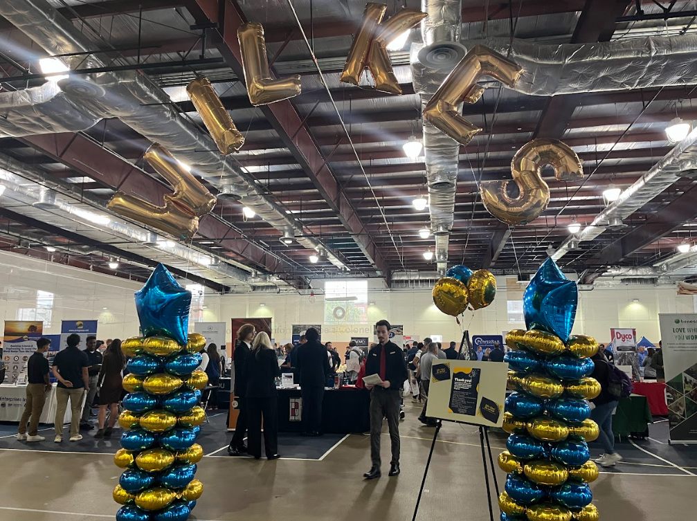 The career fair displayed an archway made from blue and gold balloons before entering the variety of employer tables.