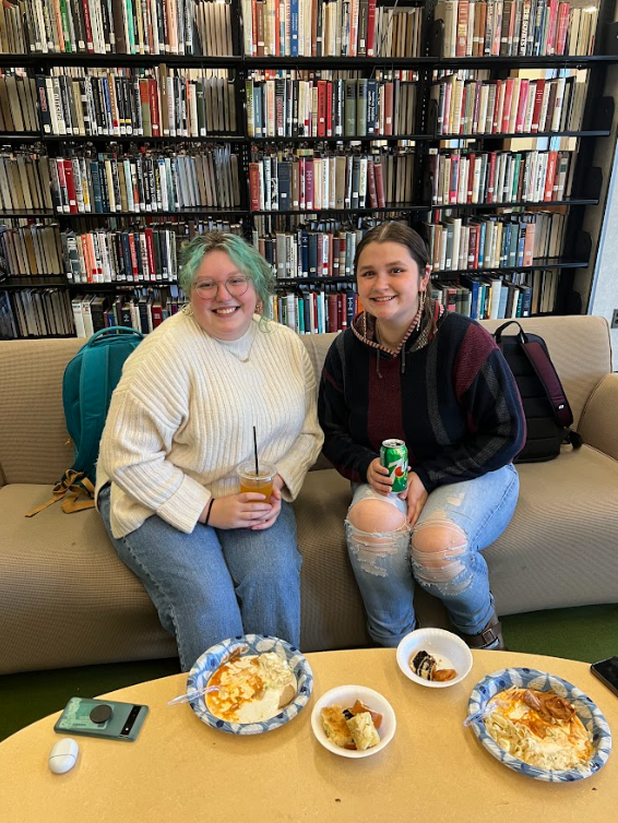 Left, Grace Gluszak (junior, public administration and political science major) and right, Heather Brinig (junior, international relations and political science major) enjoying some traditional favorites made by members of the Polish Committee.