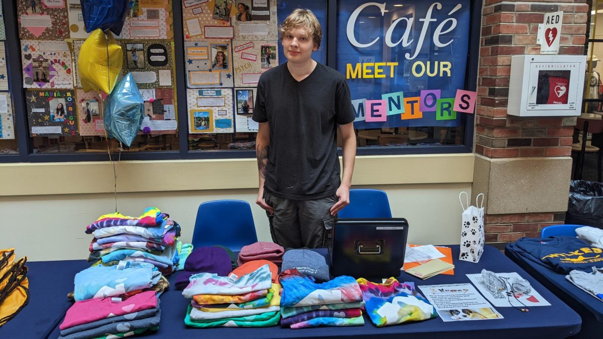 Matthew Hollay sells merchandise with all proceeds going to the Griffin Pond Animal Shelter.