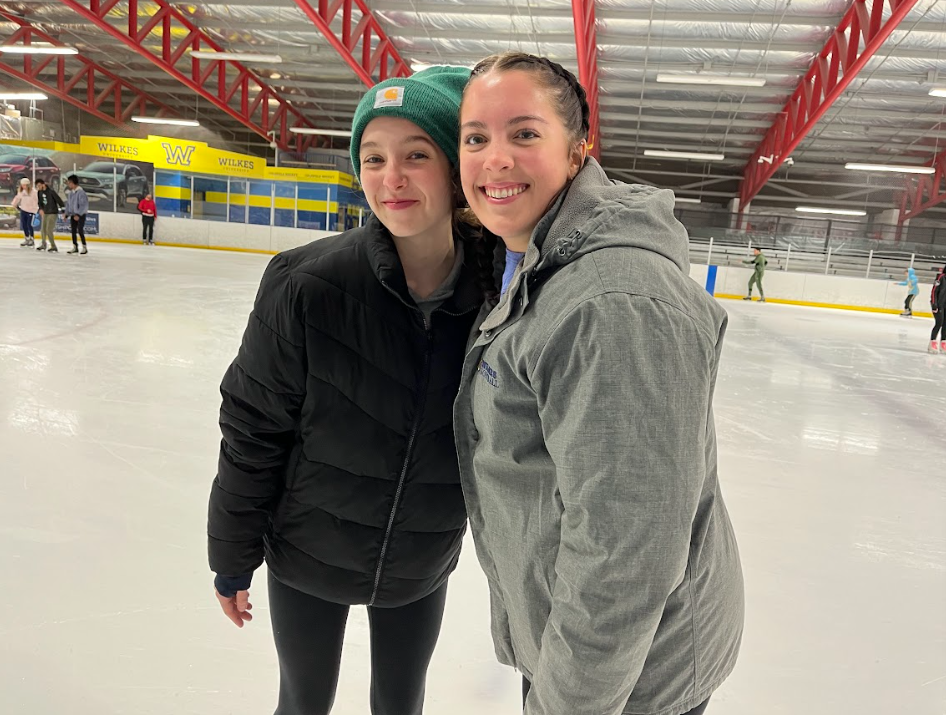 Kellie Scott (left) and Kayla Burleson (right) pose for a picture together on the ice.