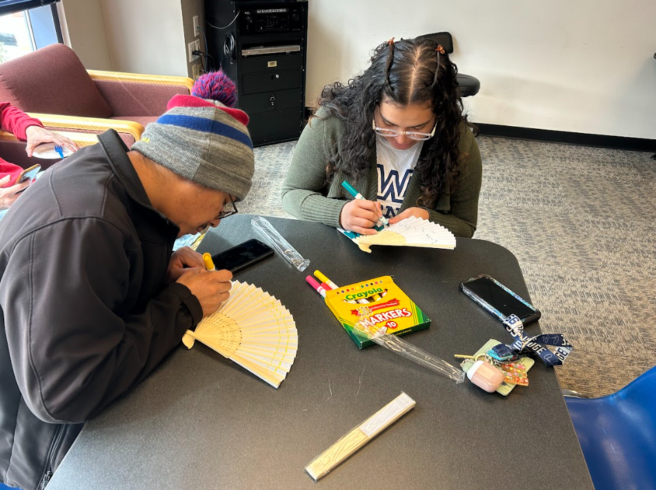 Abner Yanguez (left) and Marielis Pinto (right) make Spanish inspired fans, or “abanico.” They are used throughout Spain and particularly in clubs, Dewar said.