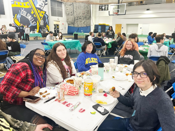 From left, Aster Rowland, junior criminology major; Savannah Evanski, senior theater major; Alyssa Brown, first year psychology major; Abigail Malin, first-year psychology major; and Ozzie Priebe, first-year, history and sociology major take a break from pickle-eating to pose for a picture at Pickels-Barre.