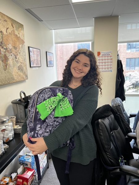Morgan Andretta, junior pharmacy major, showing off her Green Bandana which is tied to the outside of her backpack where other students can see it.