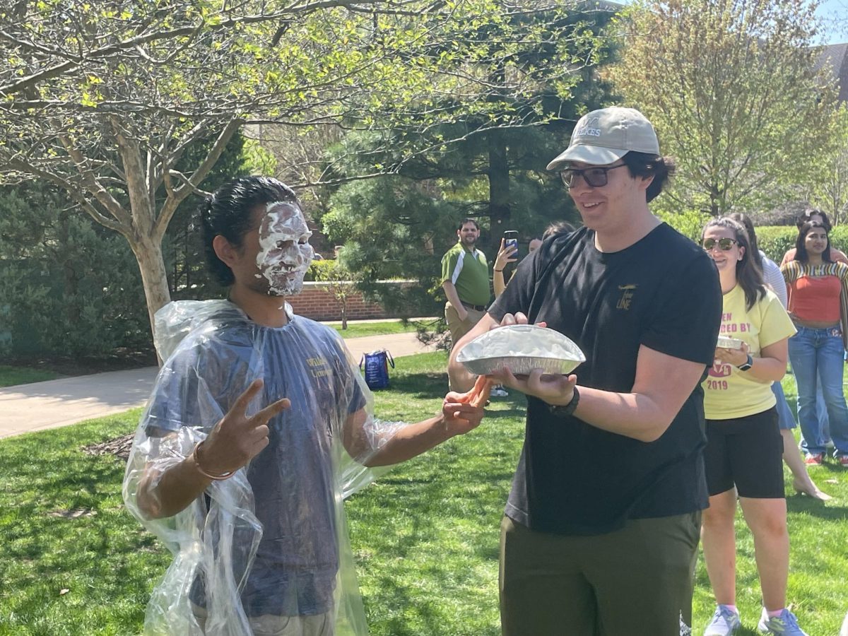 Biochemistry student Jake Middleton pies chemistry and neuroscience student Shiv Patel.