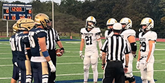 Lake-Lehman and Northwest captions line up the pregame coin toss. (Jake Mills)