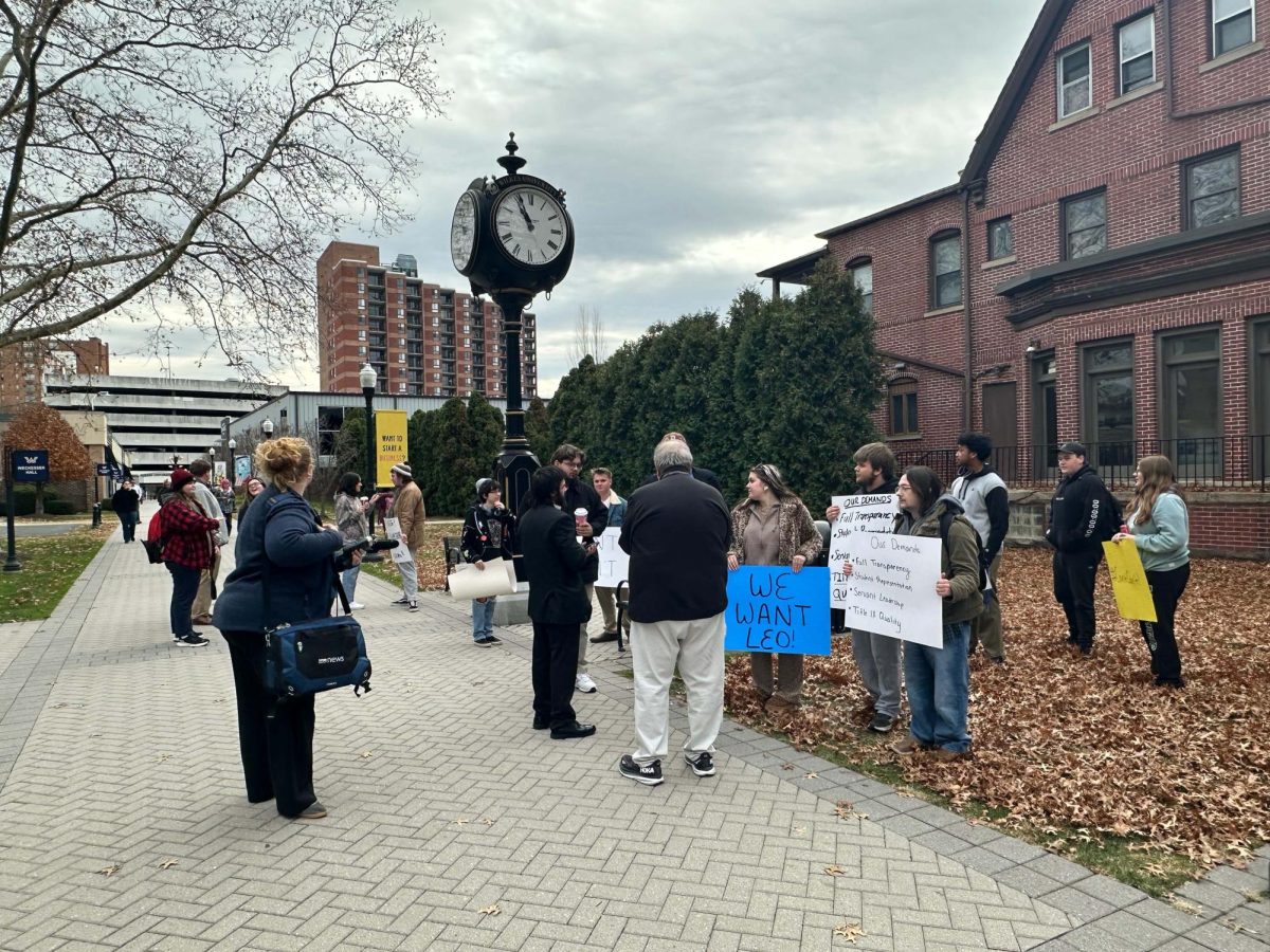 Students and local media were positioned Tuesday in the yard of Weckesser Hall even before the start of the 11 a.m. protest.
