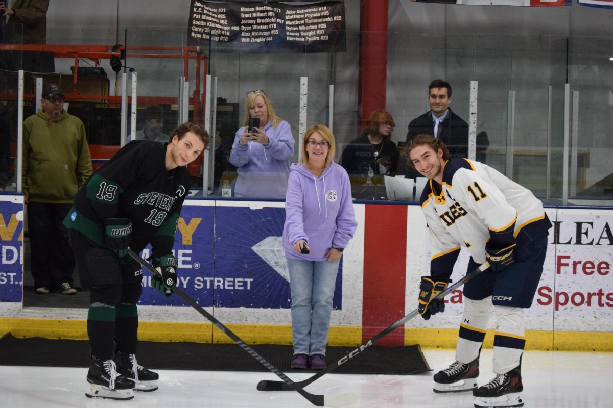 Carey Mazur takes part in the pre-game ceremonial puck drop in honor of Julia.