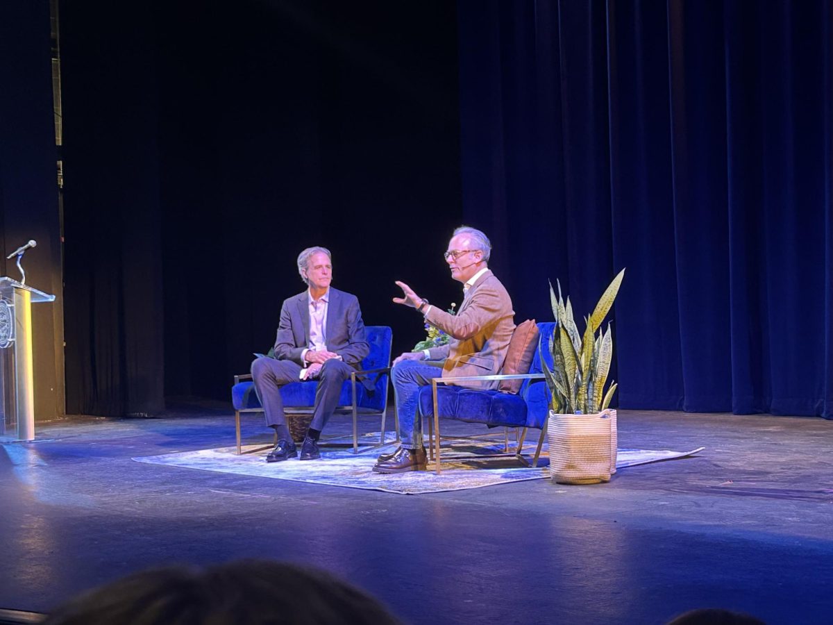 Amor Towles talking with Dr. David Hicks and the audience. 