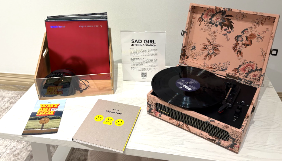The 'sad girl' listening station curated by Dana Stirling features a record playing and vinyl records of "sad" albums.
